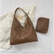 Brown vegan leather shoulder bag with matching pouch on white background