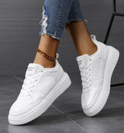 All-white sneakers with platform sole, front view
