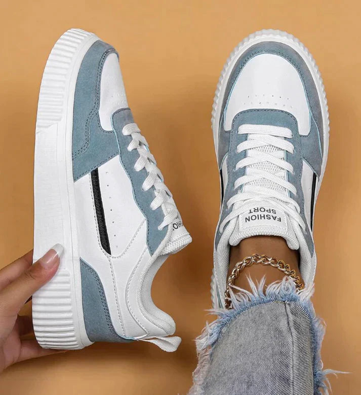 White and light blue sneakers with platform sole, side view
