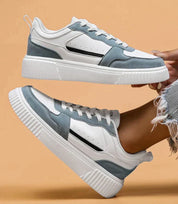 White and light blue sneakers with platform sole, elevated side view