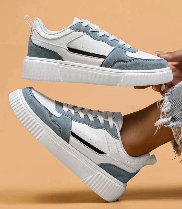 White and light blue sneakers with platform sole, elevated side view