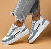 White and light blue sneakers with platform sole, angled view