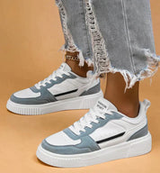 White and light blue sneakers with platform sole, front view