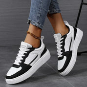 White and black sneakers with platform sole, front view
