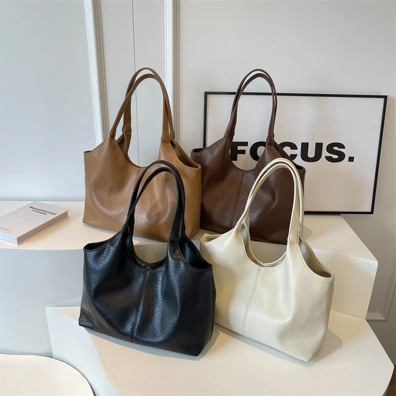 Four shoulder totes in black, brown, cream, and white