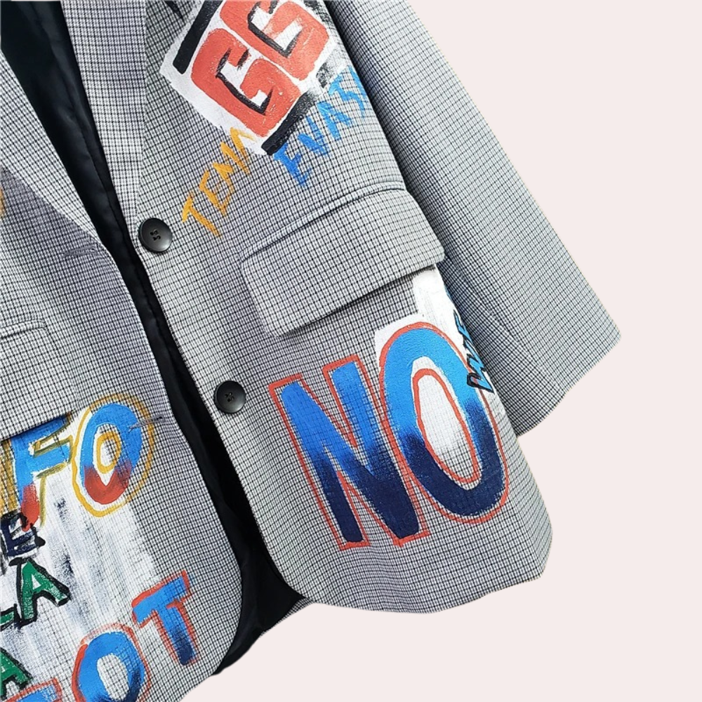 Close-up of blazer with colorful text patches and buttons