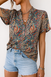 Paisley blouse with V-neck and denim shorts close-up front detail