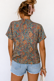 Paisley blouse with V-neck and denim shorts back view