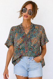 Paisley blouse with V-neck and denim shorts front view with sunglasses