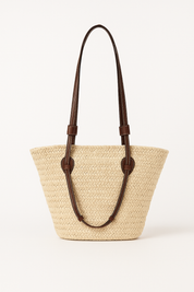 Woven straw tote bag with brown leather accents front view