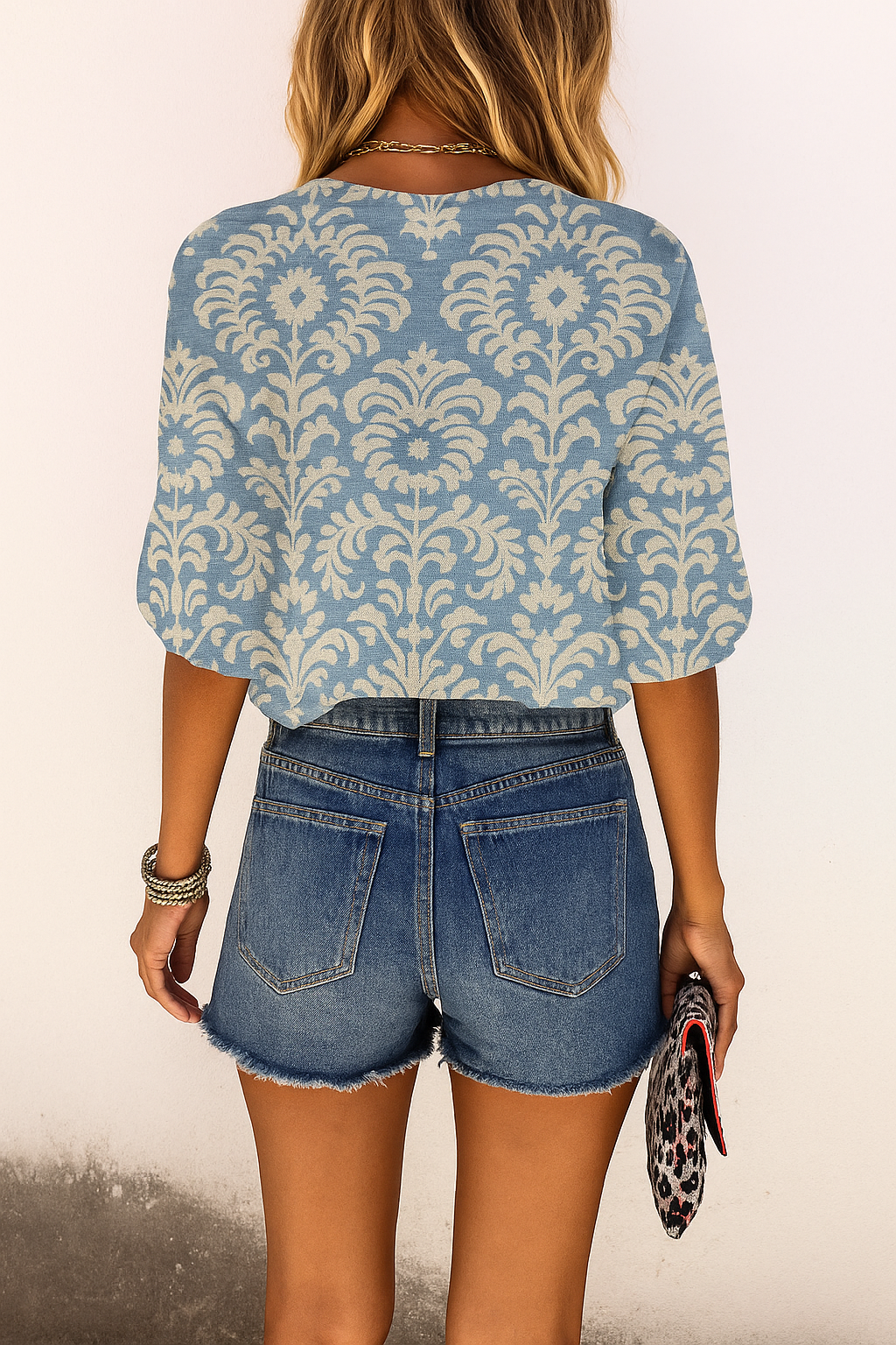Back view of damask blouse light blue with floral pattern and ruffled sleeves