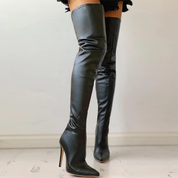 Black over-the-knee boots with gold heel, close-up side view