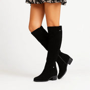 Black suede knee-high boots studio shot side view