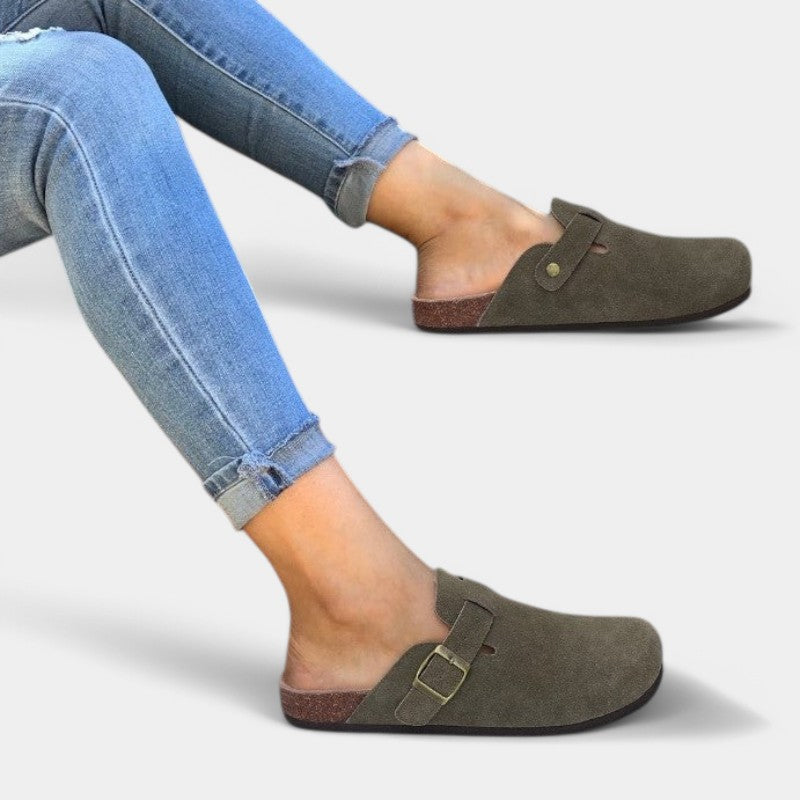 Olive suede clogs worn with jeans side view