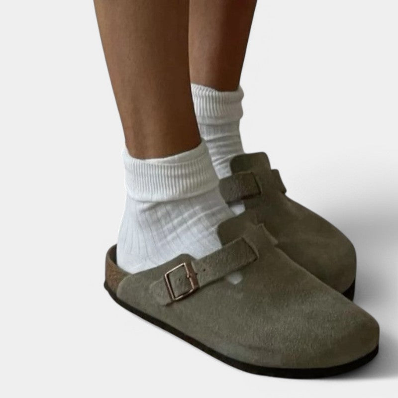 Khaki suede clogs worn with white socks side view