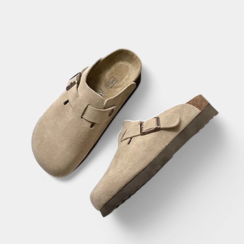 Beige suede clogs with buckle front view