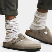 Khaki suede clogs worn with white socks side view