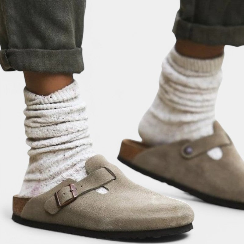 Khaki suede clogs worn with white socks side view
