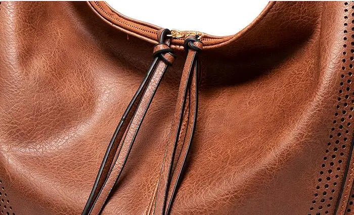 Brown leather hobo bag close-up of drawstring closure