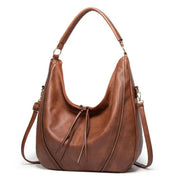 Brown leather hobo bag front view with perforated details