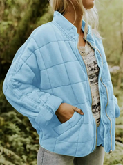 Blue quilted bomber jacket angled front view