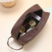 Brown toiletry bag open showing contents