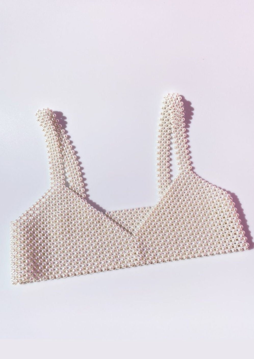Pearl bralette white flat lay showcasing intricate design