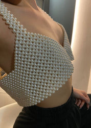 Pearl bralette white worn with black pants, close-up on shoulder