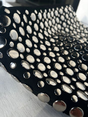 Close-up of silver studs on black hobo bag