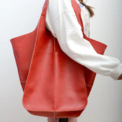 Red slouchy tote with large exterior pockets, front view