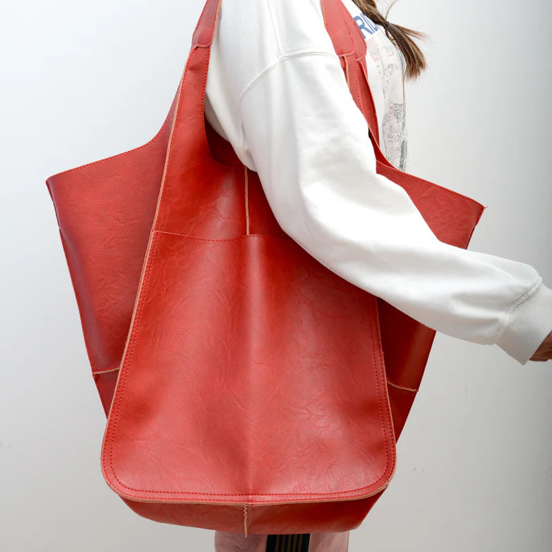 Red slouchy tote with large exterior pockets, front view