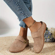 Beige perforated clogs with gold buckle side view
