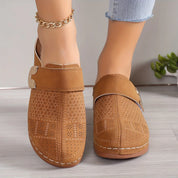 Brown perforated clogs with gold buckle side view