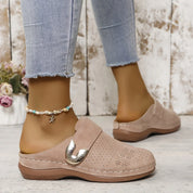 Beige perforated clogs with gold buckle front view