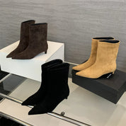 Suede ankle boots in black, brown, and beige, side view