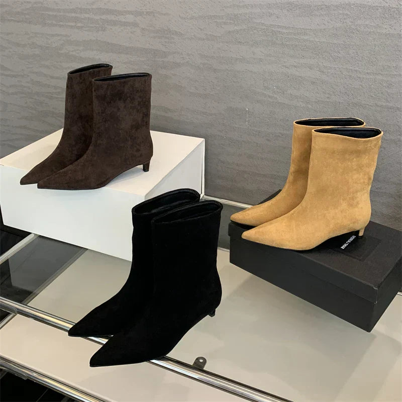 Suede ankle boots in black, brown, and beige, side view
