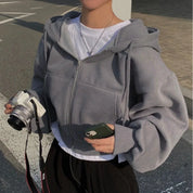 Grijze hoodie met rits en zakken, zijkant weergave