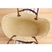 Woven straw tote bag interior view showing spacious beige lining