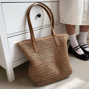 Woven straw tote bag beige side view with person