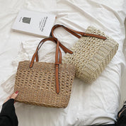 Woven cross-stitch tote bag beige on bed with book