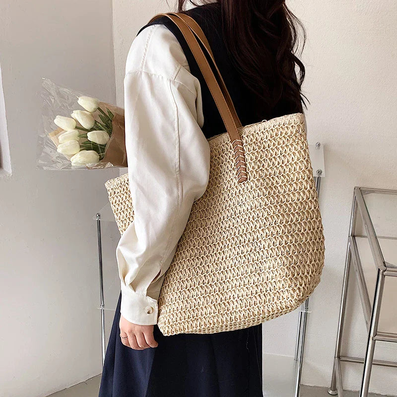 Woven straw tote bag beige worn with black jacket