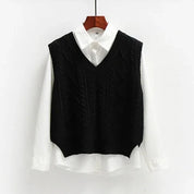 Black knitted vest with cable pattern over white shirt front view