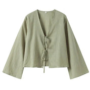 Light green blouse with tie detail hanging view