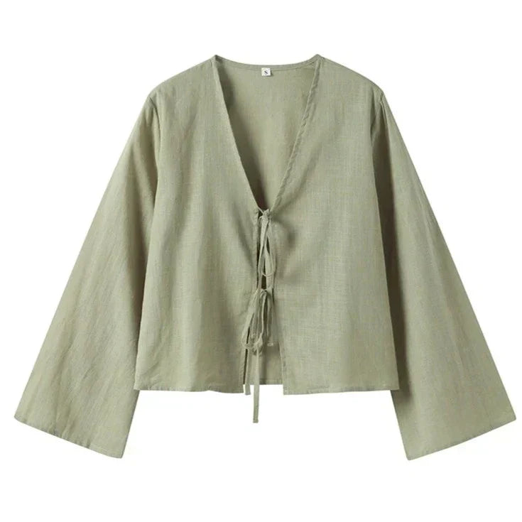 Light green blouse with tie detail hanging view