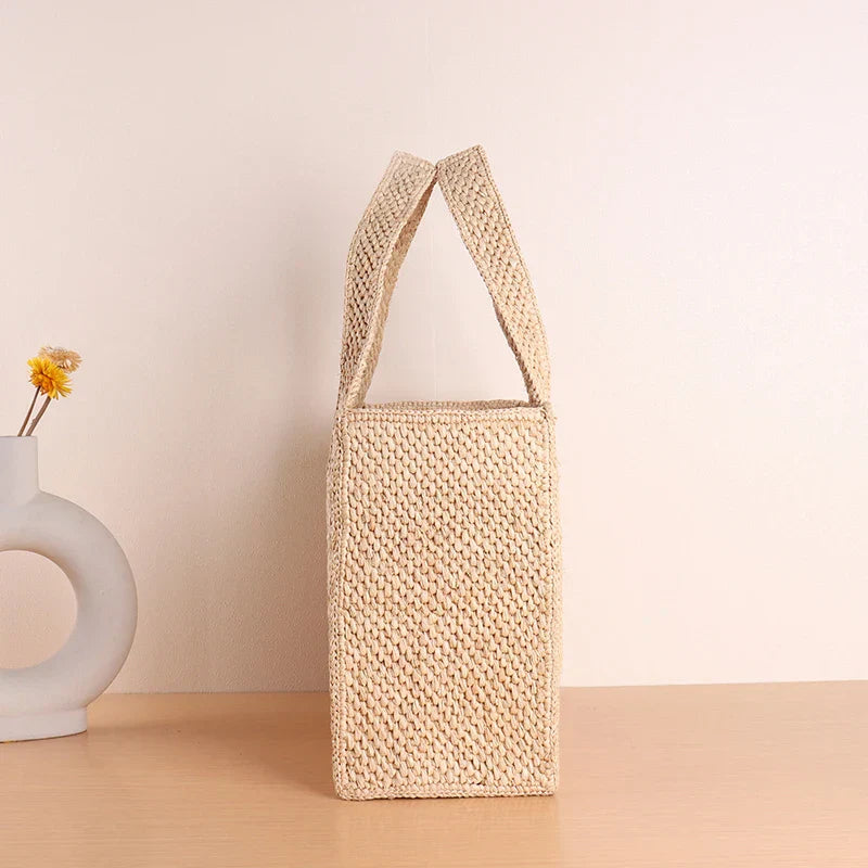 Woven straw tote bag beige front view with handles