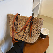 Woven cross-stitch tote bag beige on table with coffee cup