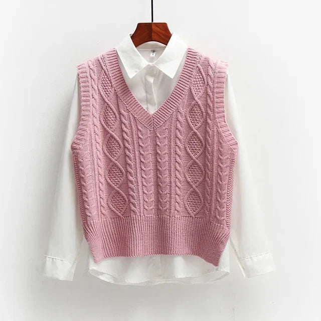 Pink knitted vest with cable pattern over white shirt front view