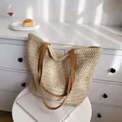 Woven straw tote bag beige top view on table