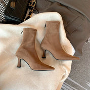 Beige suede ankle boots with pointed toe, close-up detail
