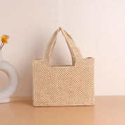 Woven straw tote bag beige front view with vase